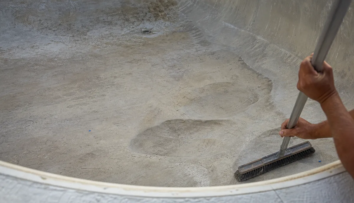 The floor of an empty pool with the liner out