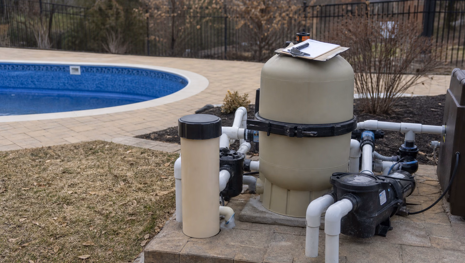 A dry pool equipment pad being inspected before the season