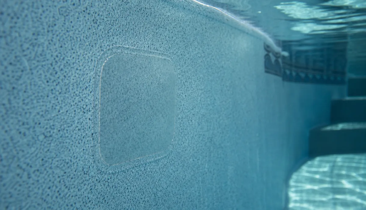 A vinyl liner patch being applied underwater
