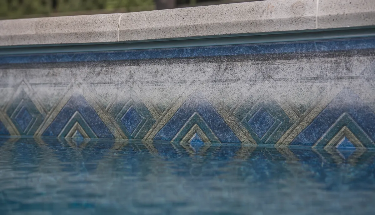 Brittle, chalked vinyl along a pool waterline