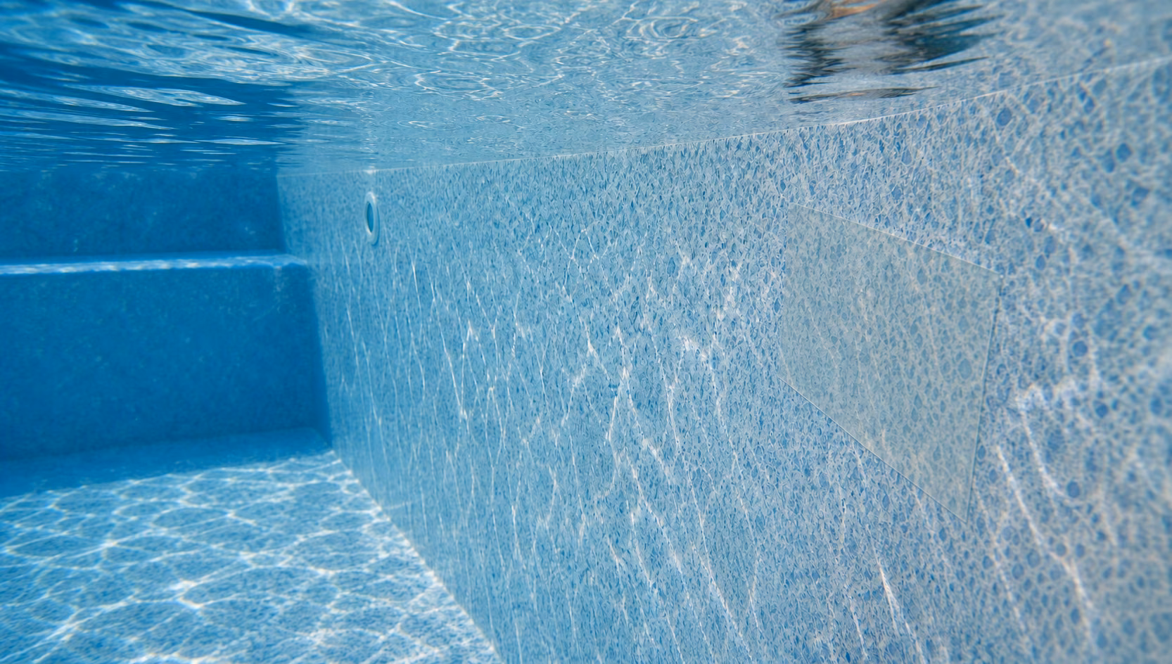 A vinyl liner patch being smoothed on underwater