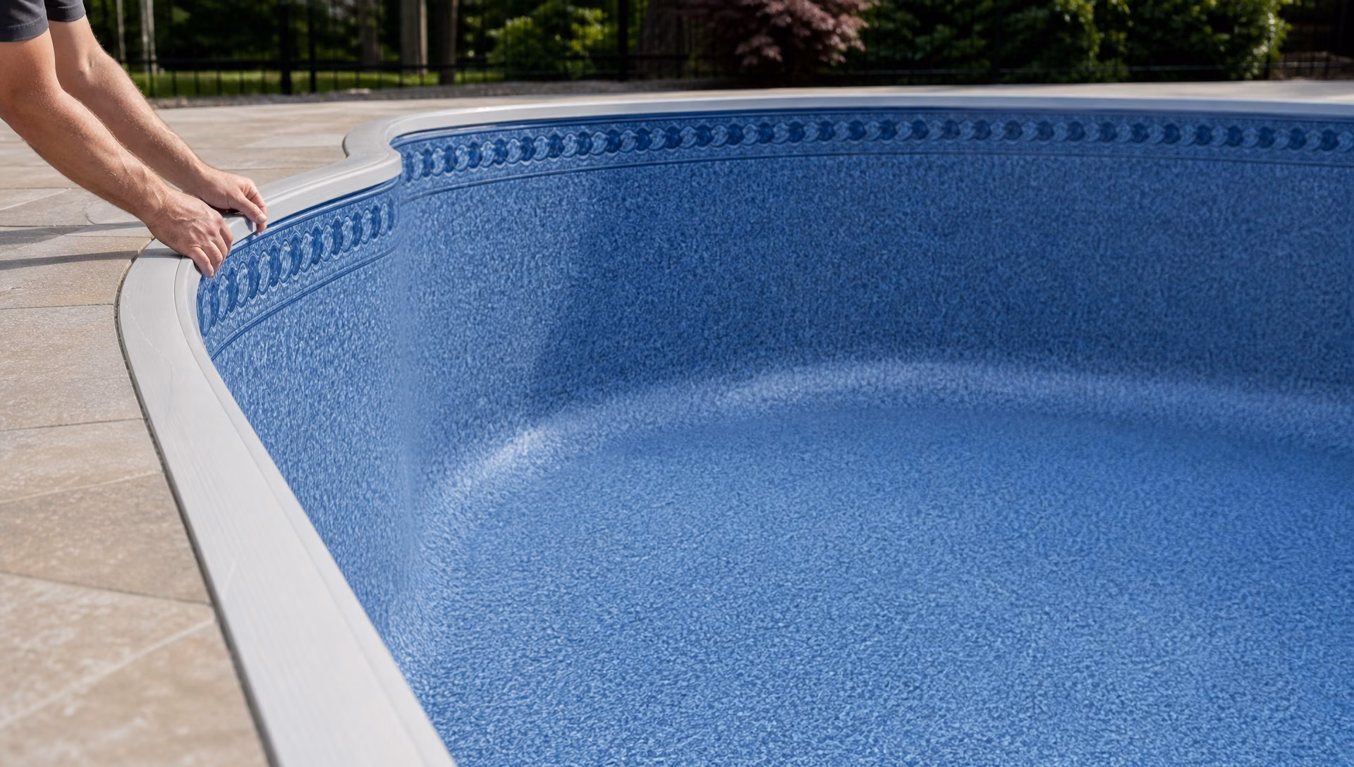 A new vinyl liner seated in an empty pool shell