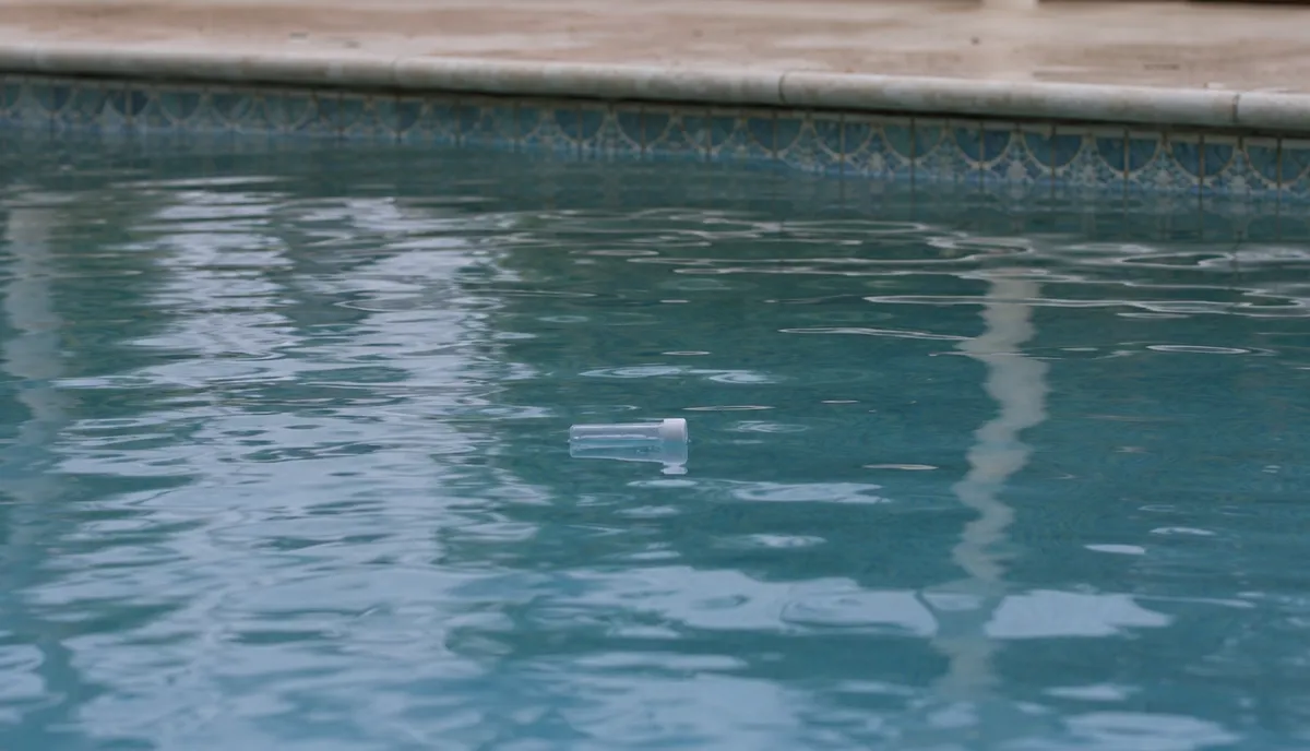 A pool water sample being drawn for testing