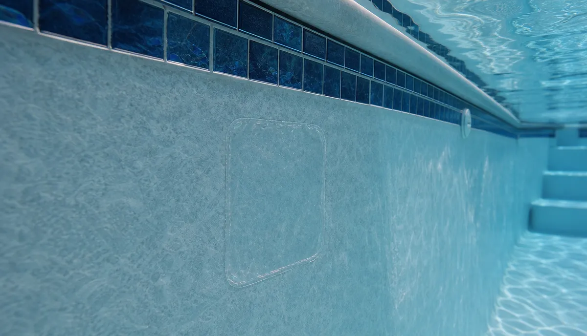 A vinyl liner patch being applied underwater