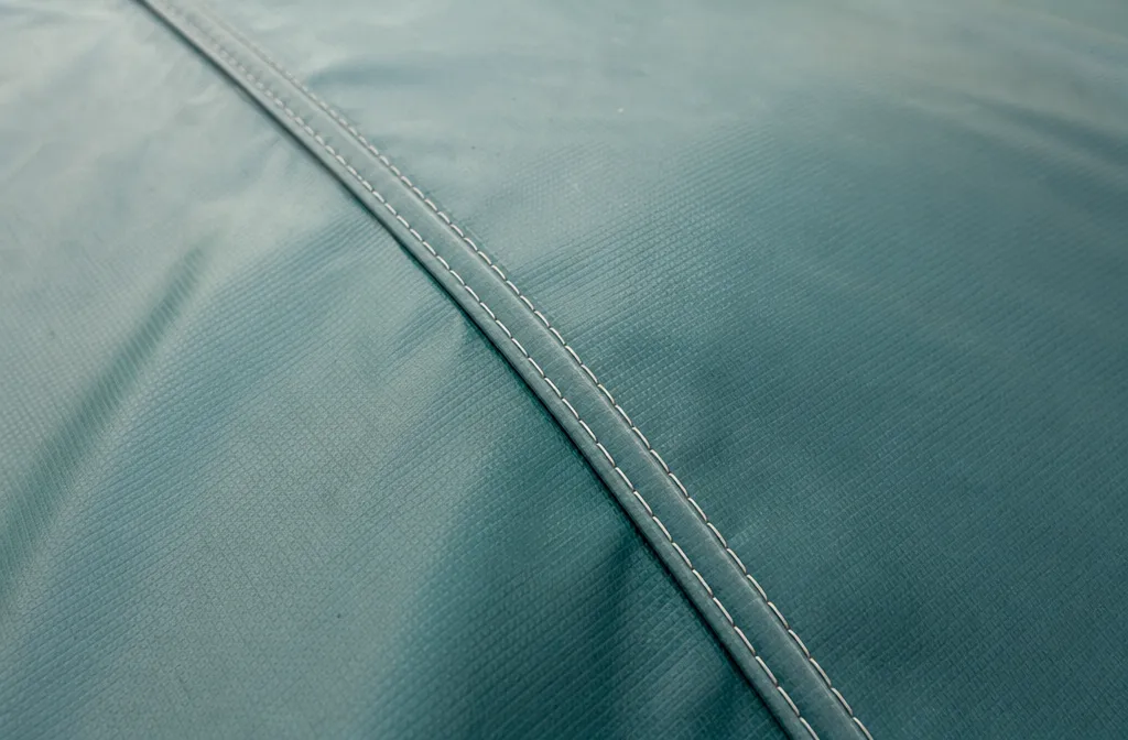 The stitched seam of a pool safety cover