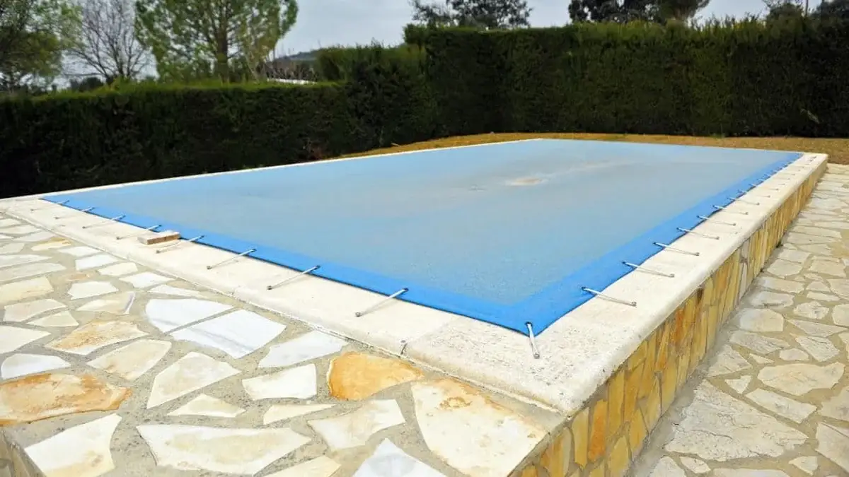 An in-ground pool closed and covered for the Northeast Ohio winter